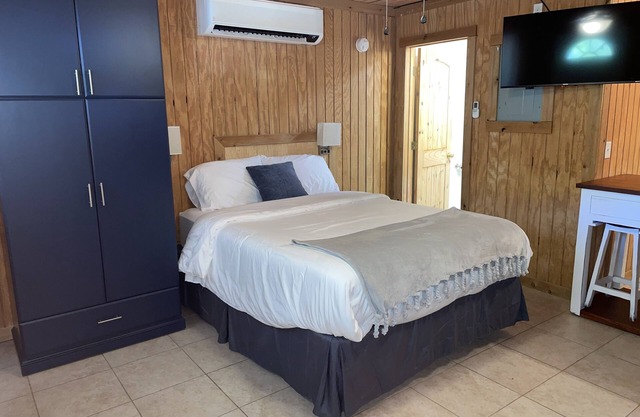 Studio cabin #2 with lake view, boat dock access, outdoor seating, and firepit.