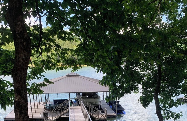 Stunning Lake home with private dock, covered parking and sweeping water views.