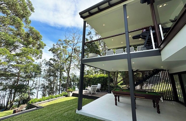 Stunning lakefront retreat on Smiths Lake. Swim, boat, & fish from the backyard!