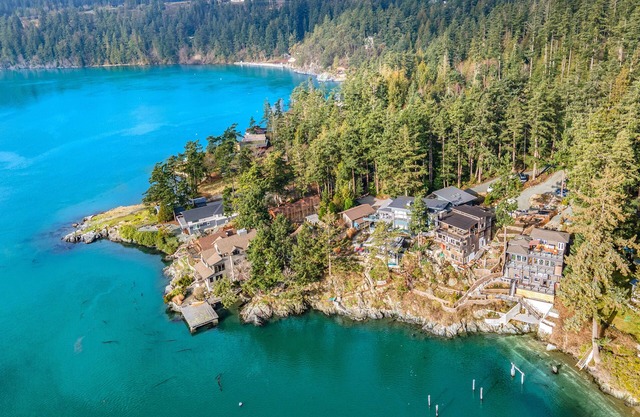 Stunning waterfront home with panoramic views, fireplace, balcony, & firepit