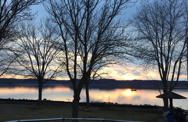 Sunset Waters: Serene Retreat on the Mississippi River Shoreline Fisher Friendly