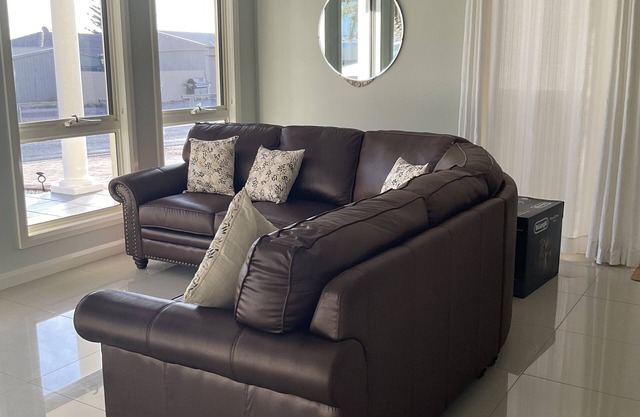 The happy place-Comfortable 3 bedroom home with sea views. Steps to the beach.