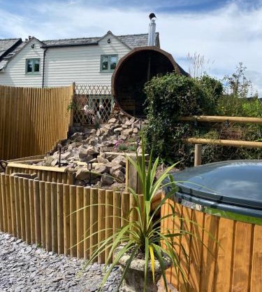 The lodge spa with sauna hot tub outdoor kitchen with firepit area