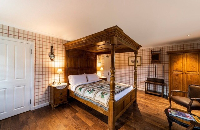 The wooden floors, vintage furniture, and tartan accents create a comfy room