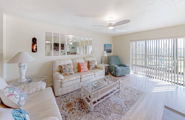 Two-story townhouse with a sunroom, heated pool, hot tub, & tennis courts