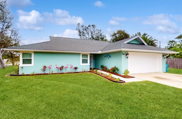 Updated home with beach access, games, grill, & central AC - snowbird-friendly