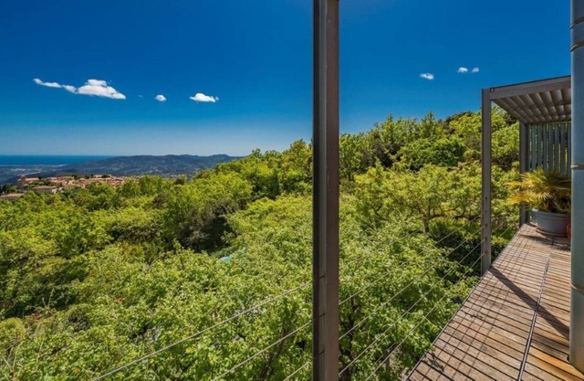 Villa among the treetops, overlooking the hilltop village of Cabris and the sea.