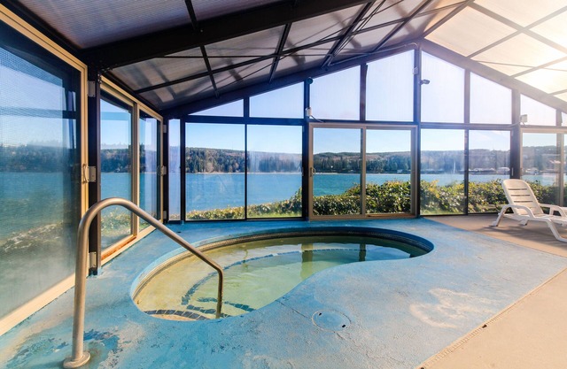 Water-view condo with deck, grill, yard games, resort pools, hot tub, and gym