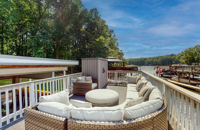 Waterfront home with boat dock, outdoor bar/TV, firepit, and yard games