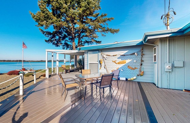 Waterfront home with panoramic bay views, deck, fireplace & beach access