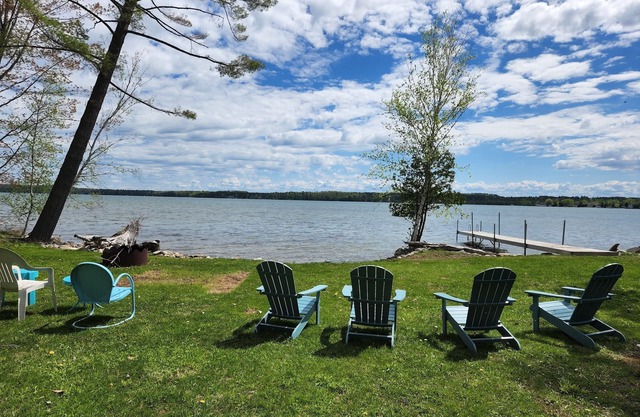 Waterfront log home on Elk Lake with dock and mooring, window A/C. Pet ok.