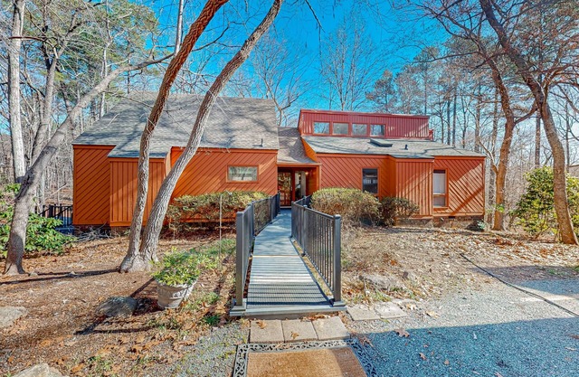 Woodland acreage with 60' deck on gurgling brook, pizza oven, rec area & library