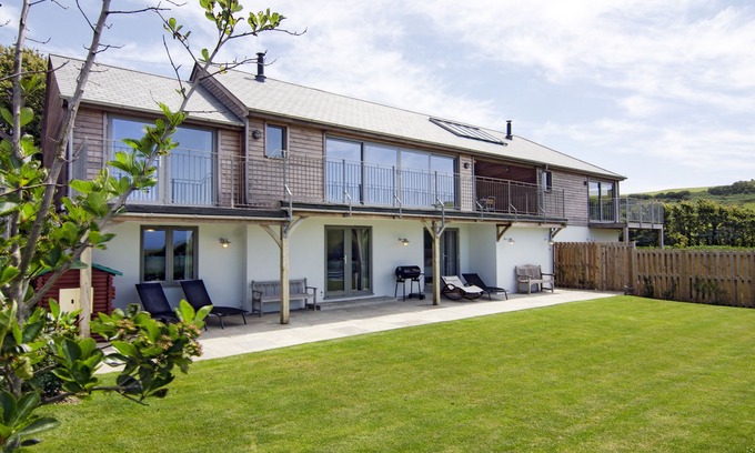Bantham Casa | 5 * Gran familia y casa que admite mascotas con vistas a la costa de la isla de Burgh.