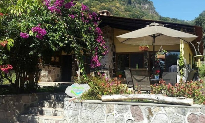 Panajachel Cabaña | Cozy country cottage with wooden ceilings and stone walls within nature reserve.