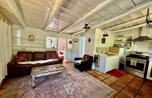 San Cristobal Cabina | Log Casita Overlooking Pond and Waterfall near Taos, New Mexico