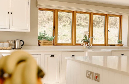 Acrefair Casa | A luxurious riverside cottage with stunning views, a hot tub, and fishing access.