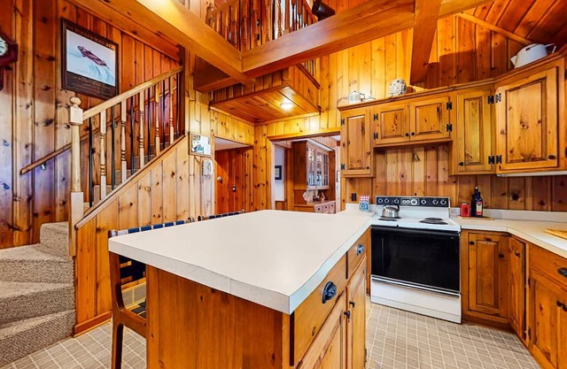 Lakeside retreat with four bedrooms, yard, dock, balcony, & washer/dryer