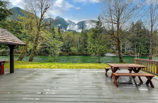 Delightful river front cabin with new hot tub and mountain views.