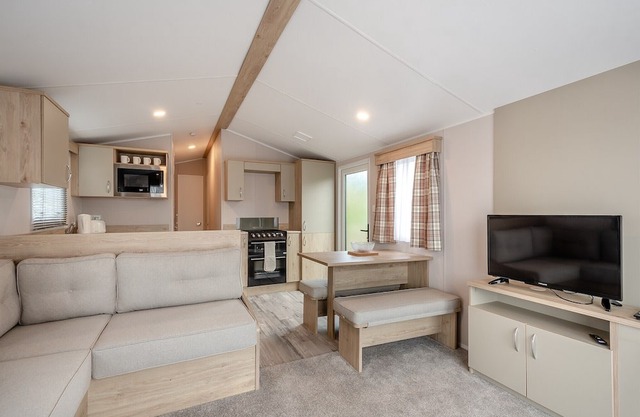 This spacious 2 bedroom caravan sleeps 4 people in one double and one twin bedroom.