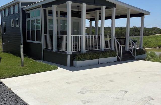 Pond-Side Pet-Friendly Tiny Home Features Multi-Bed Layout and Covered Patio Overlooking Tranquil Fo